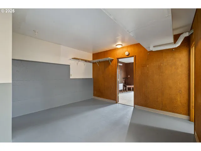 a hallway with wooden floor and furniture