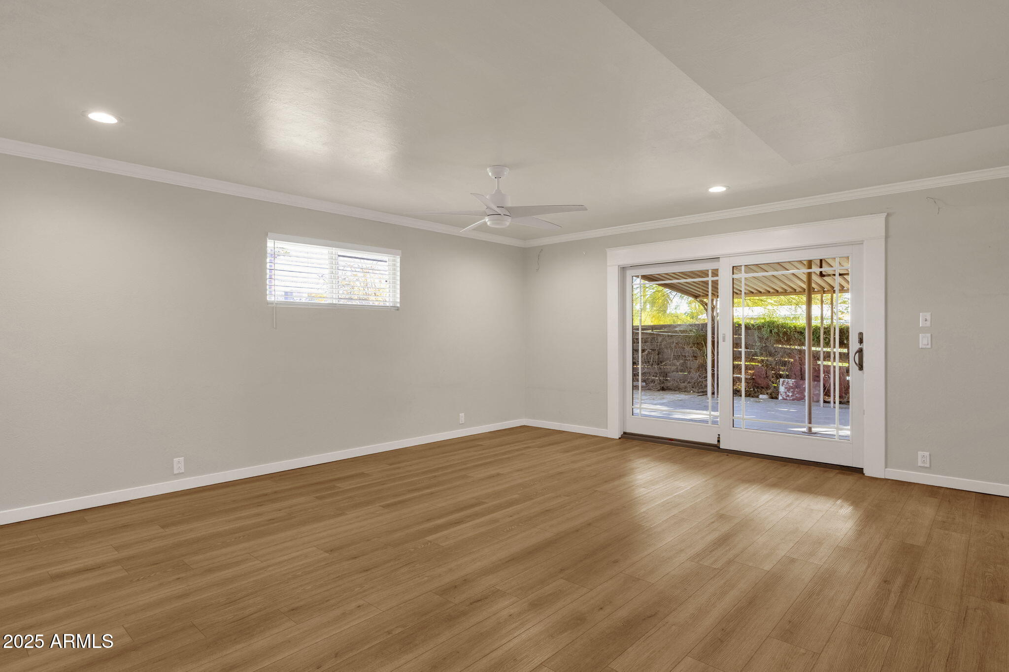 2139 South La Rosa Drive Tempe, AZ 85282 - Photo 3 of 29 a view of an empty room with wooden floor and a window
