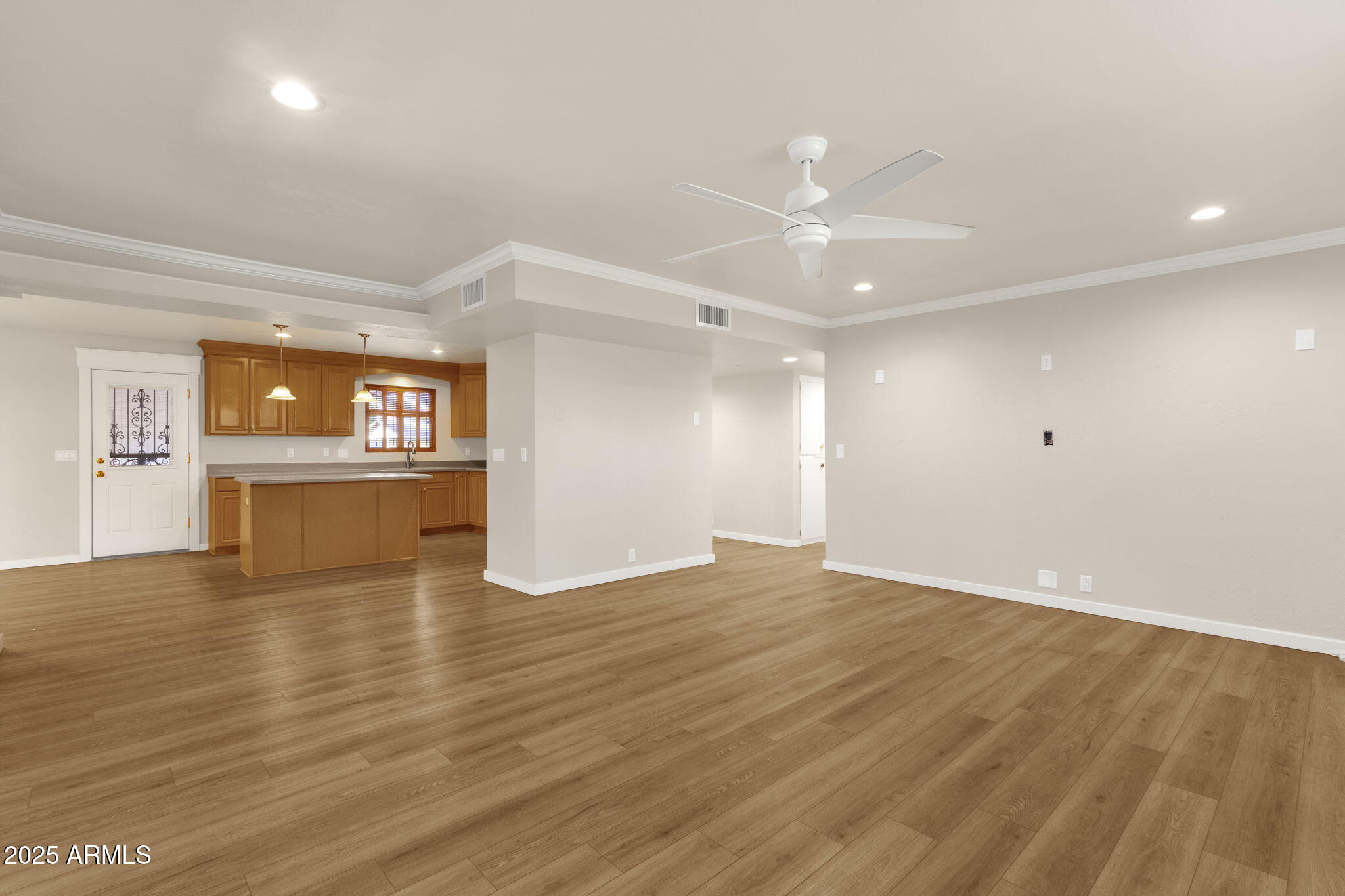 2139 South La Rosa Drive Tempe, AZ 85282 - Photo 5 of 29 a view of an empty room with window and wooden floor