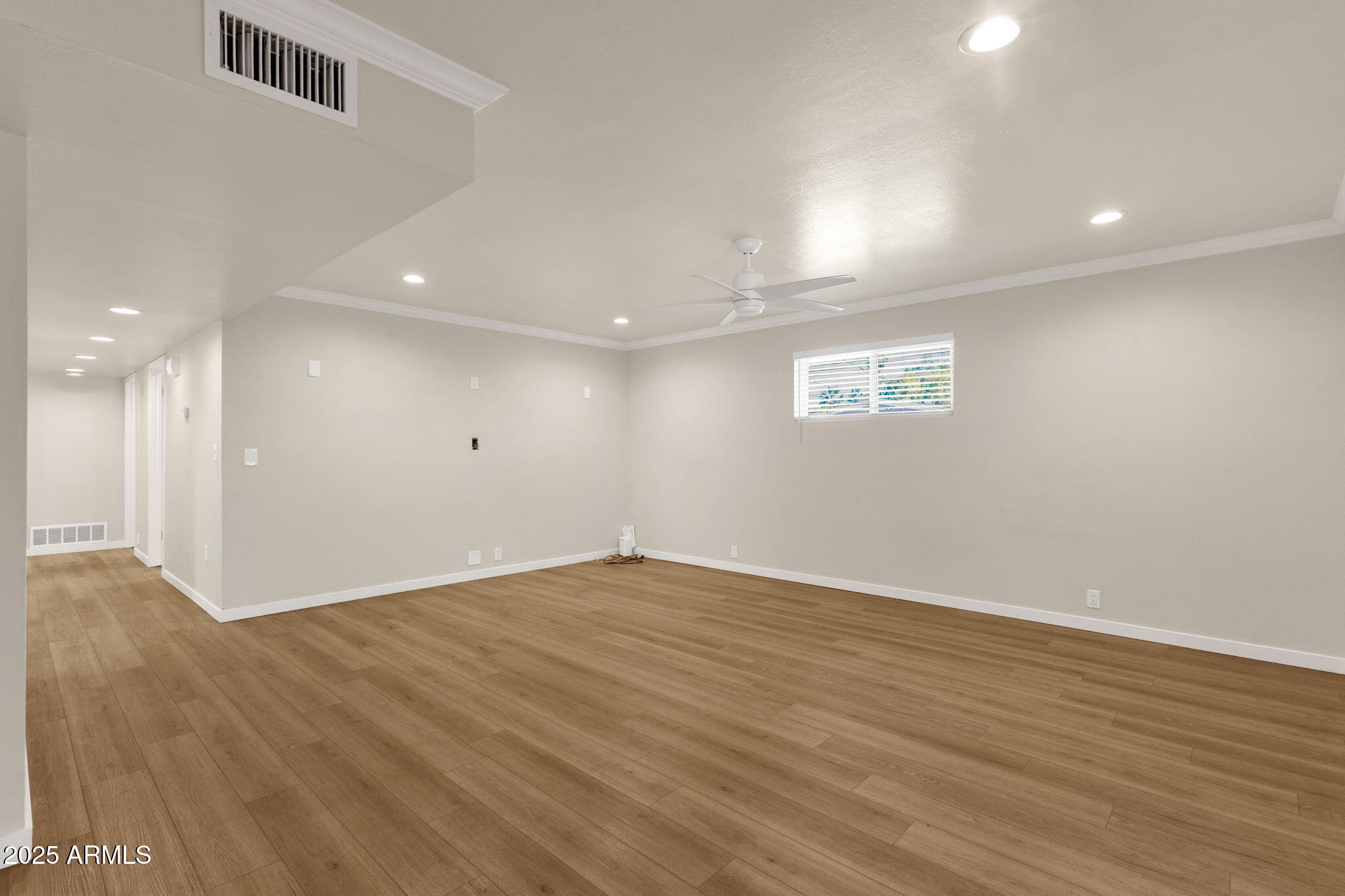 2139 South La Rosa Drive Tempe, AZ 85282 - Photo 6 of 29 an empty room with wooden floor and windows