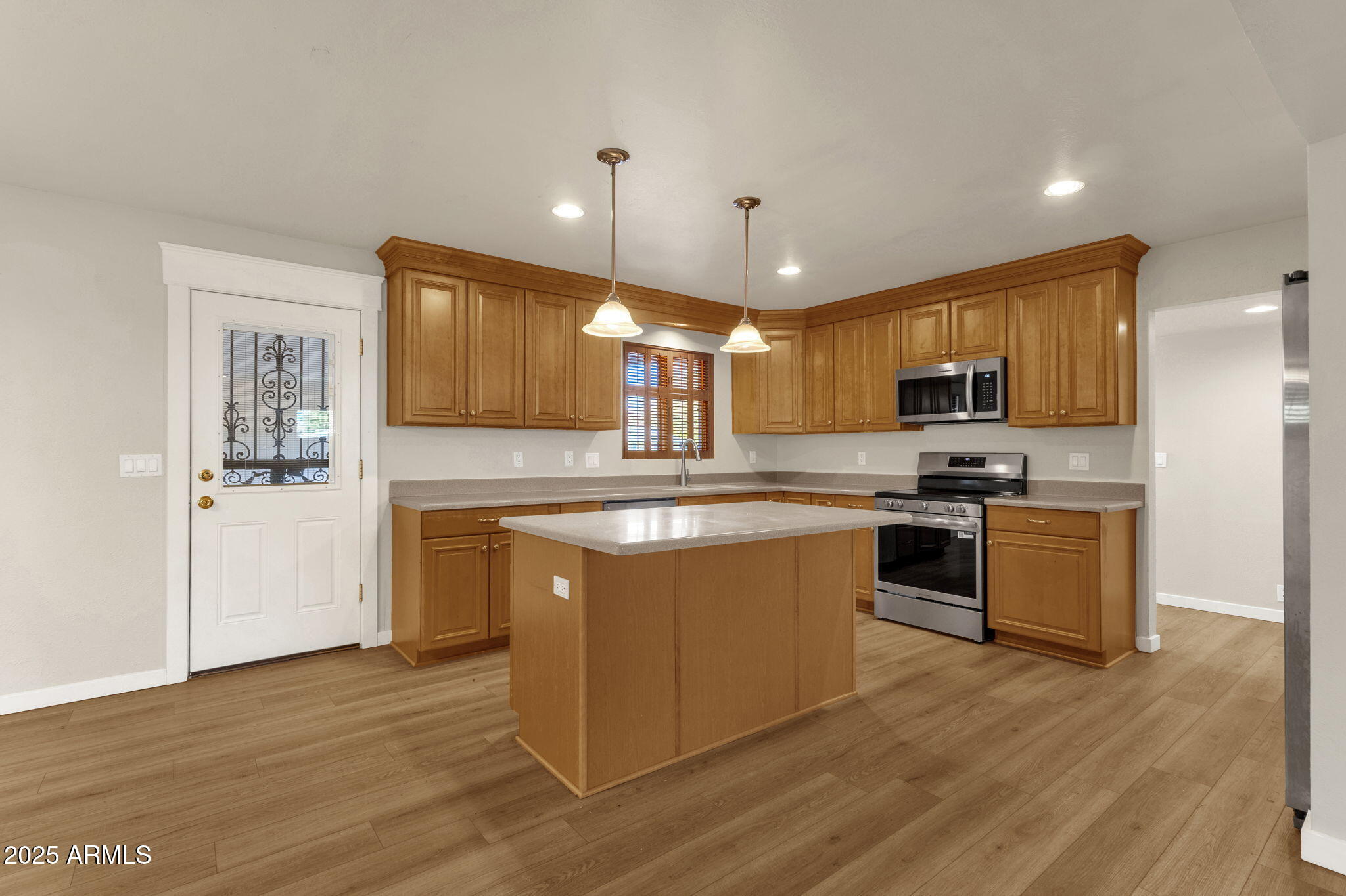 2139 South La Rosa Drive Tempe, AZ 85282 - Photo 7 of 29 a large kitchen with stainless steel appliances granite countertop a stove a sink a refrigerator and a microwave