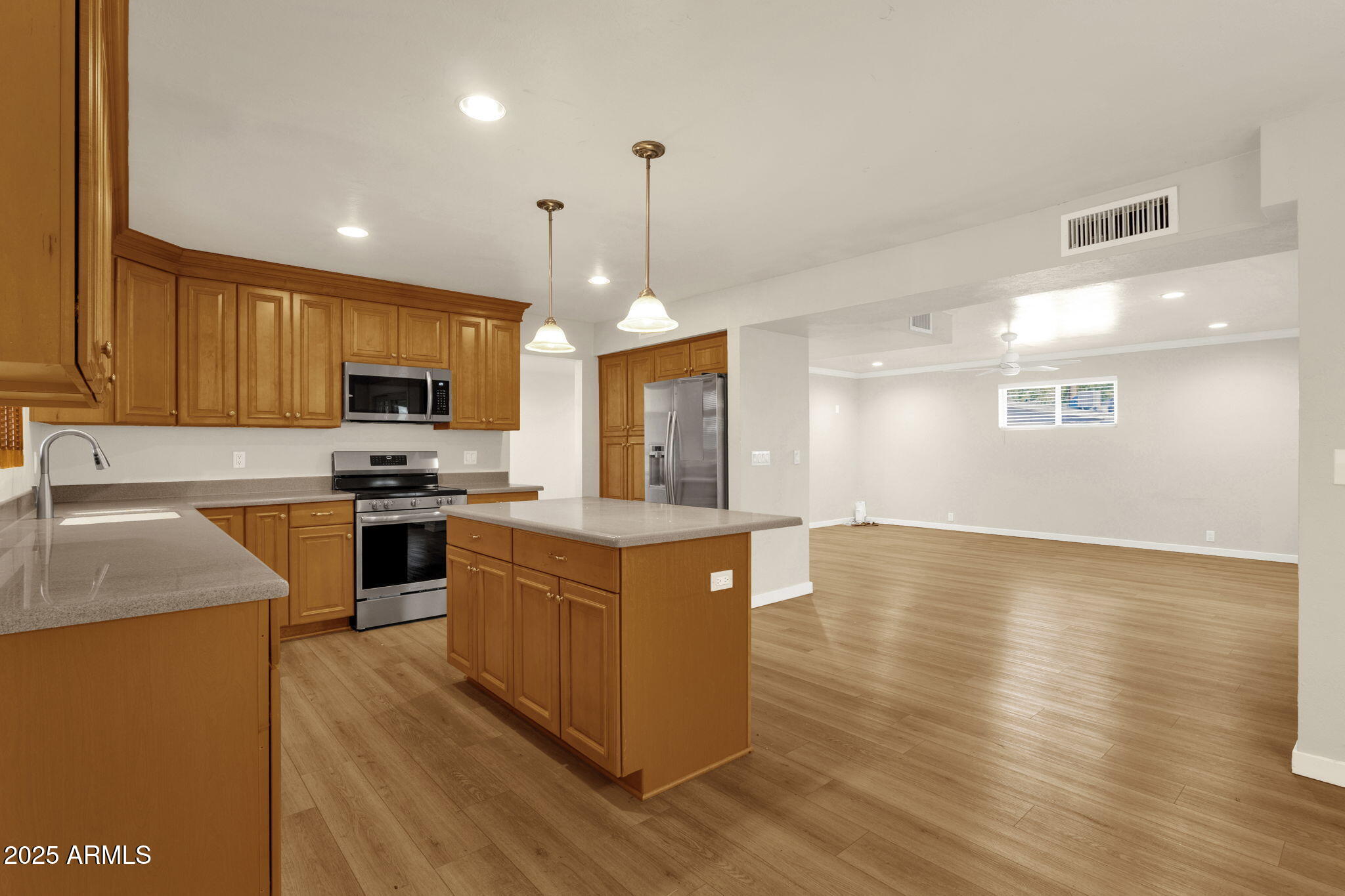 2139 South La Rosa Drive Tempe, AZ 85282 - Photo 8 of 29 a kitchen with granite countertop a stove top oven a sink dishwasher a refrigerator and a dining table with wooden floor