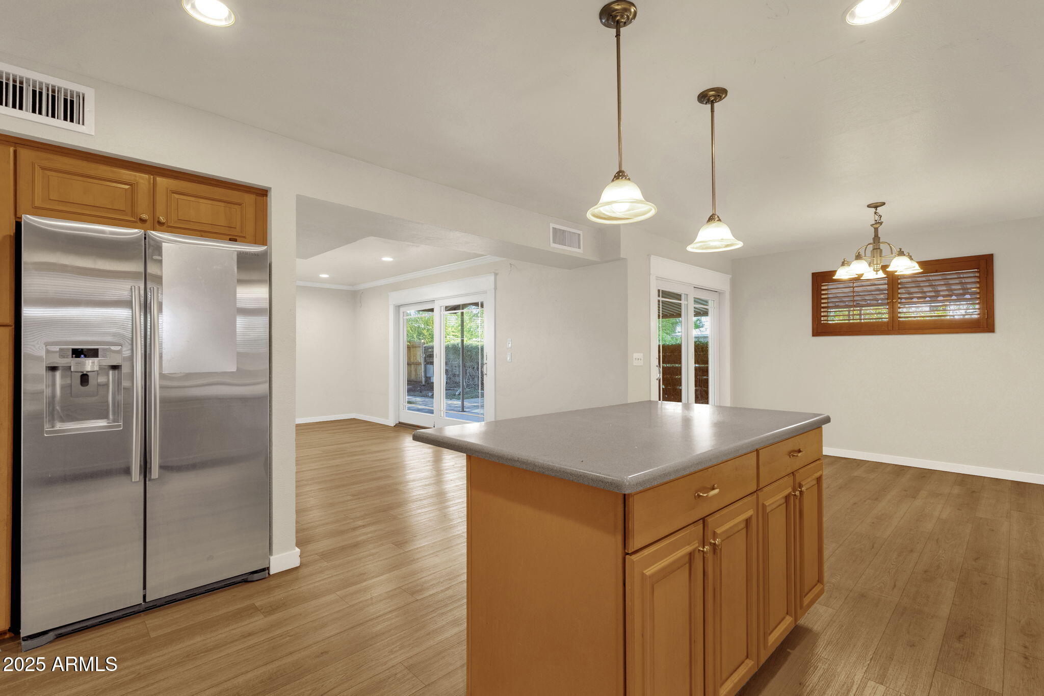 2139 South La Rosa Drive Tempe, AZ 85282 - Photo 9 of 29 a kitchen with stainless steel appliances granite countertop a refrigerator a sink and a wooden floor