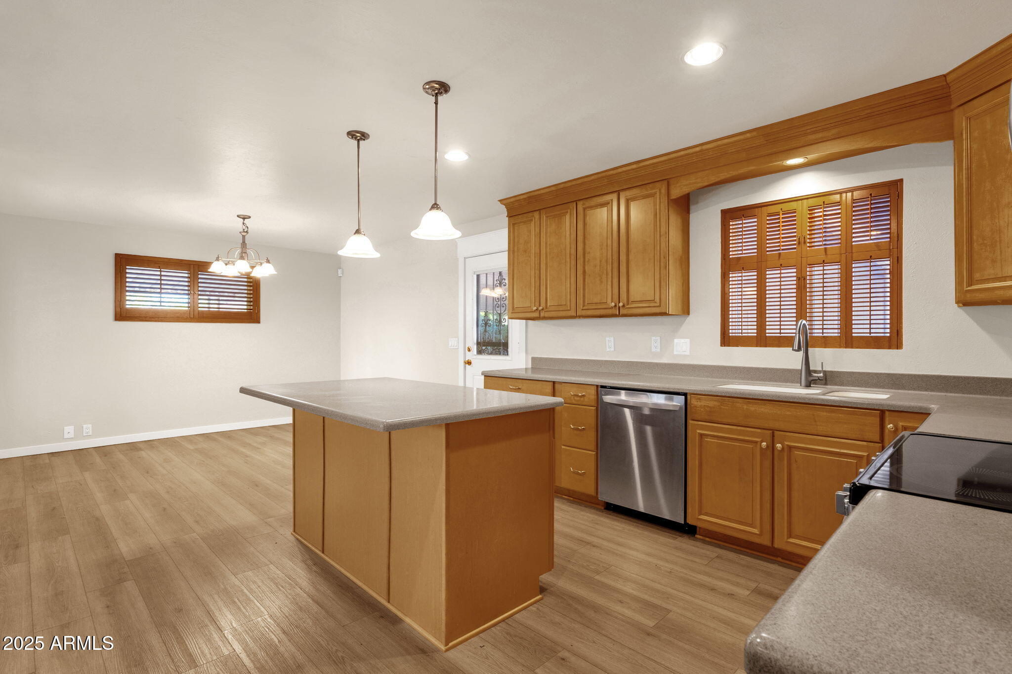 2139 South La Rosa Drive Tempe, AZ 85282 - Photo 10 of 29 a kitchen with stainless steel appliances granite countertop a sink a stove a refrigerator and island with wooden floor
