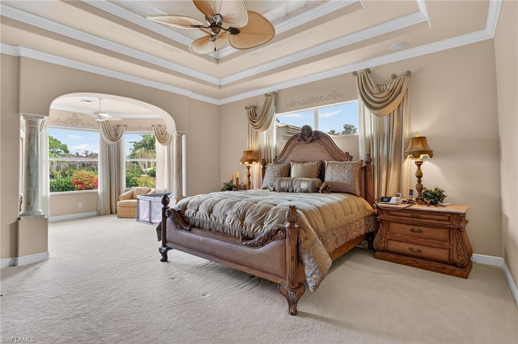 1964 Rialto Way Alva, FL 33920 - Photo 18 of 50 a spacious bedroom with a bed and a chandelier