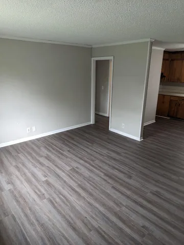 a view of a kitchen with wooden floor and a sink