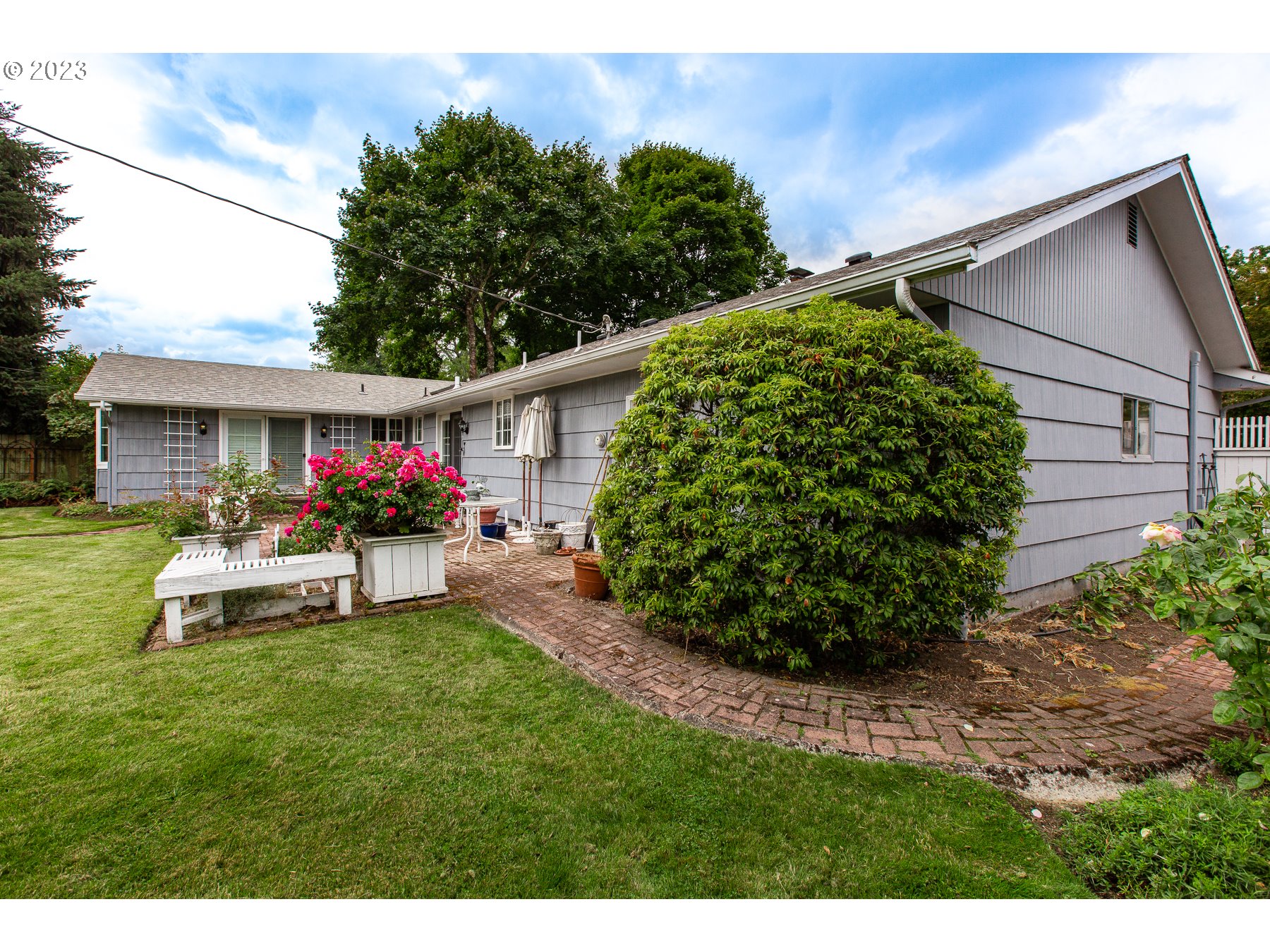 2727 Villa Way Springfield, OR 97477 - Photo 40 of 41 a view of a house with a back yard and a garden