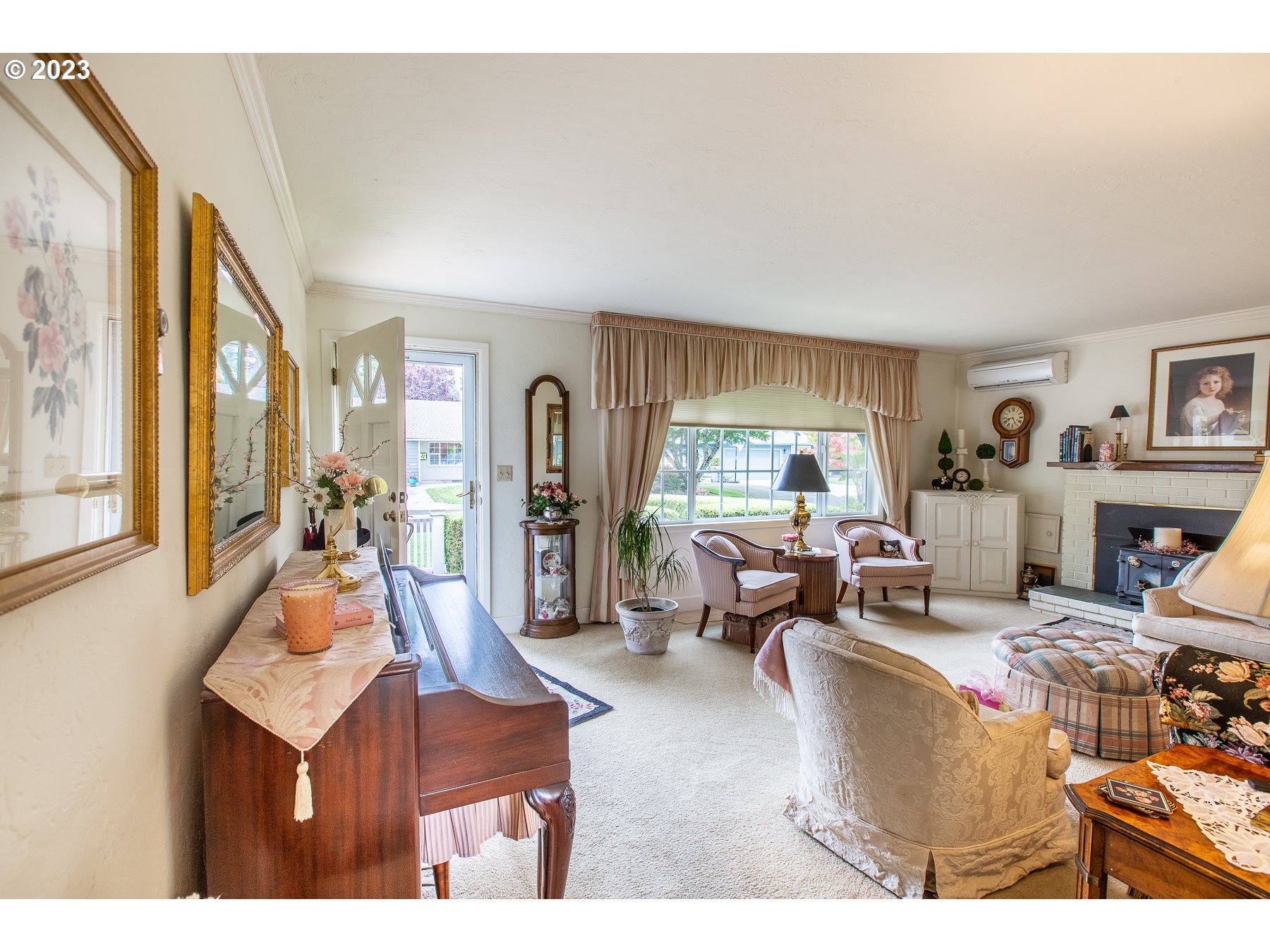 2727 Villa Way Springfield, OR 97477 - Photo 7 of 41 a living room with furniture a fireplace and a large window