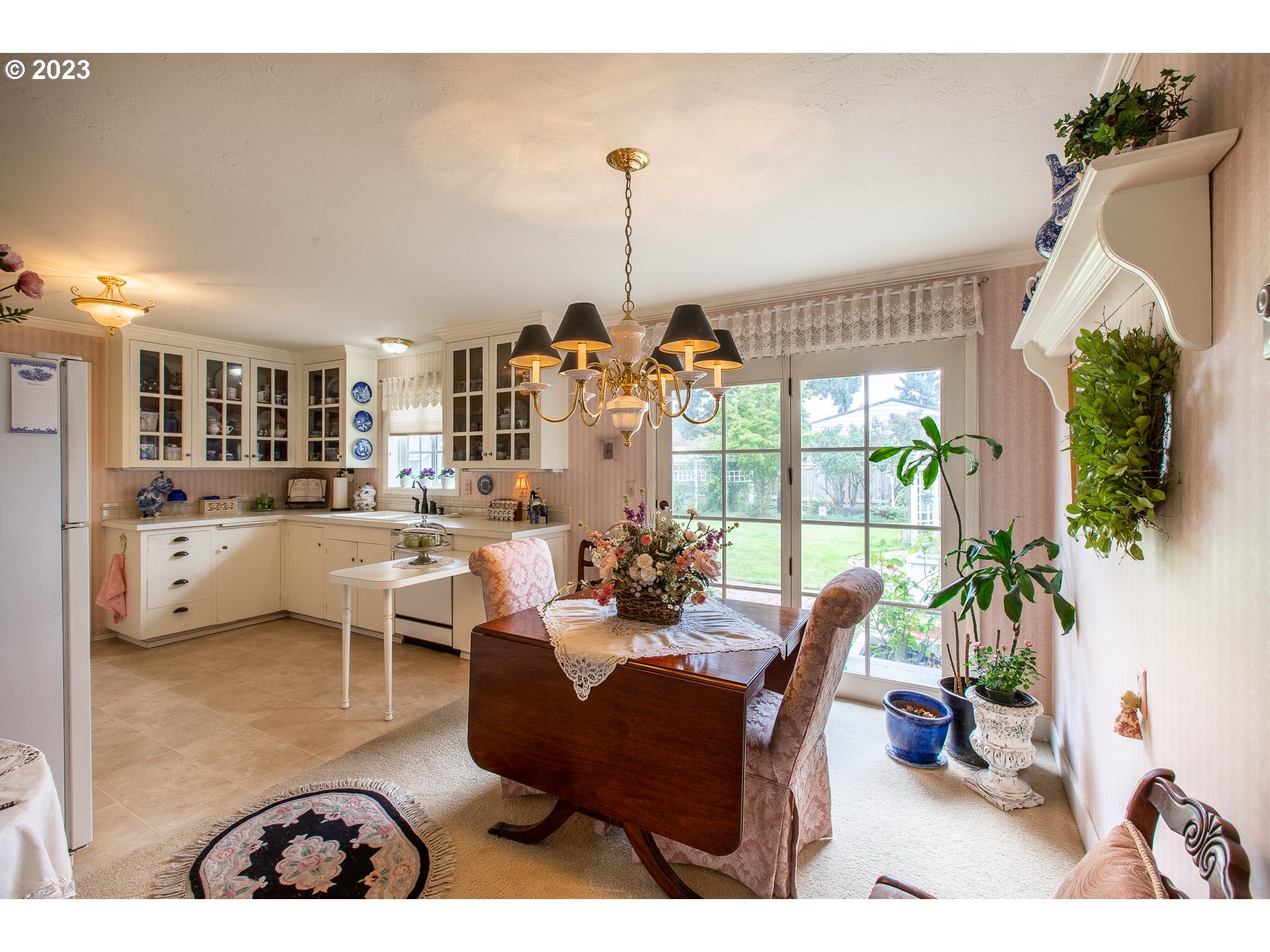 2727 Villa Way Springfield, OR 97477 - Photo 10 of 41 a living room with furniture a chandelier and a large window