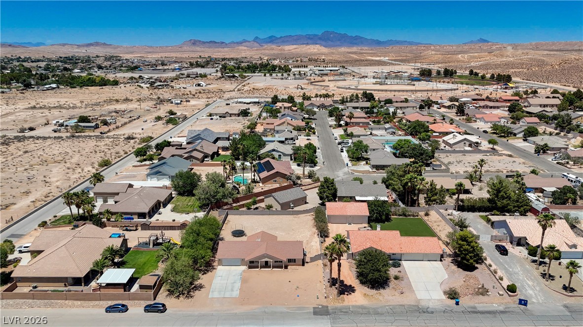 1272 Liston Avenue Logandale, NV 89021 - Photo 56 of 61 An aerial perspective reveals a vibrant neighborhood nestled against distant desert mountains.
