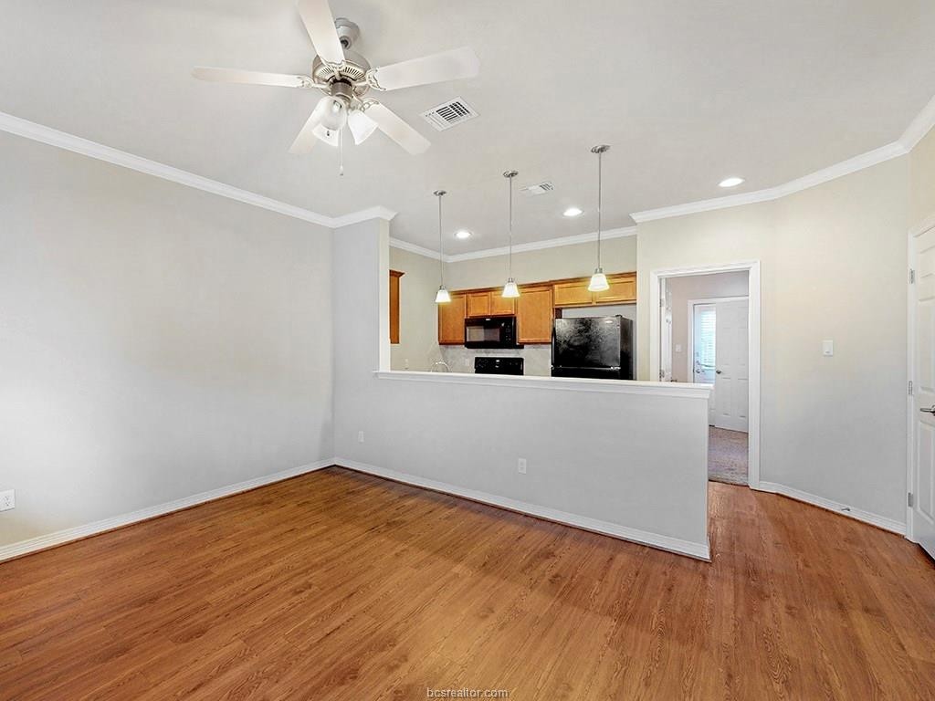1198 Jones-Butler Road, Unit 2607 College Station, TX 77840 - Photo 2 of 26 a view of a room with a ceiling fan and wooden floor