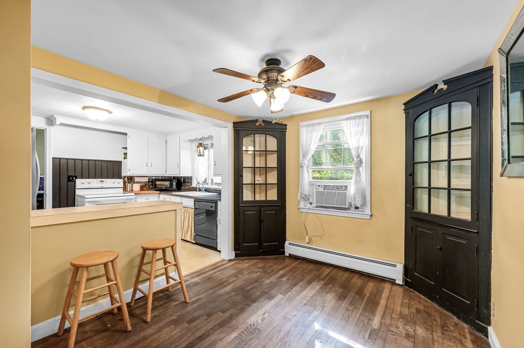 58 Bennett Road Hampden, MA 01036 - Photo 12 of 41 a kitchen with stainless steel appliances kitchen island granite countertop a refrigerator a stove a sink with a dining table and chairs with wooden floor