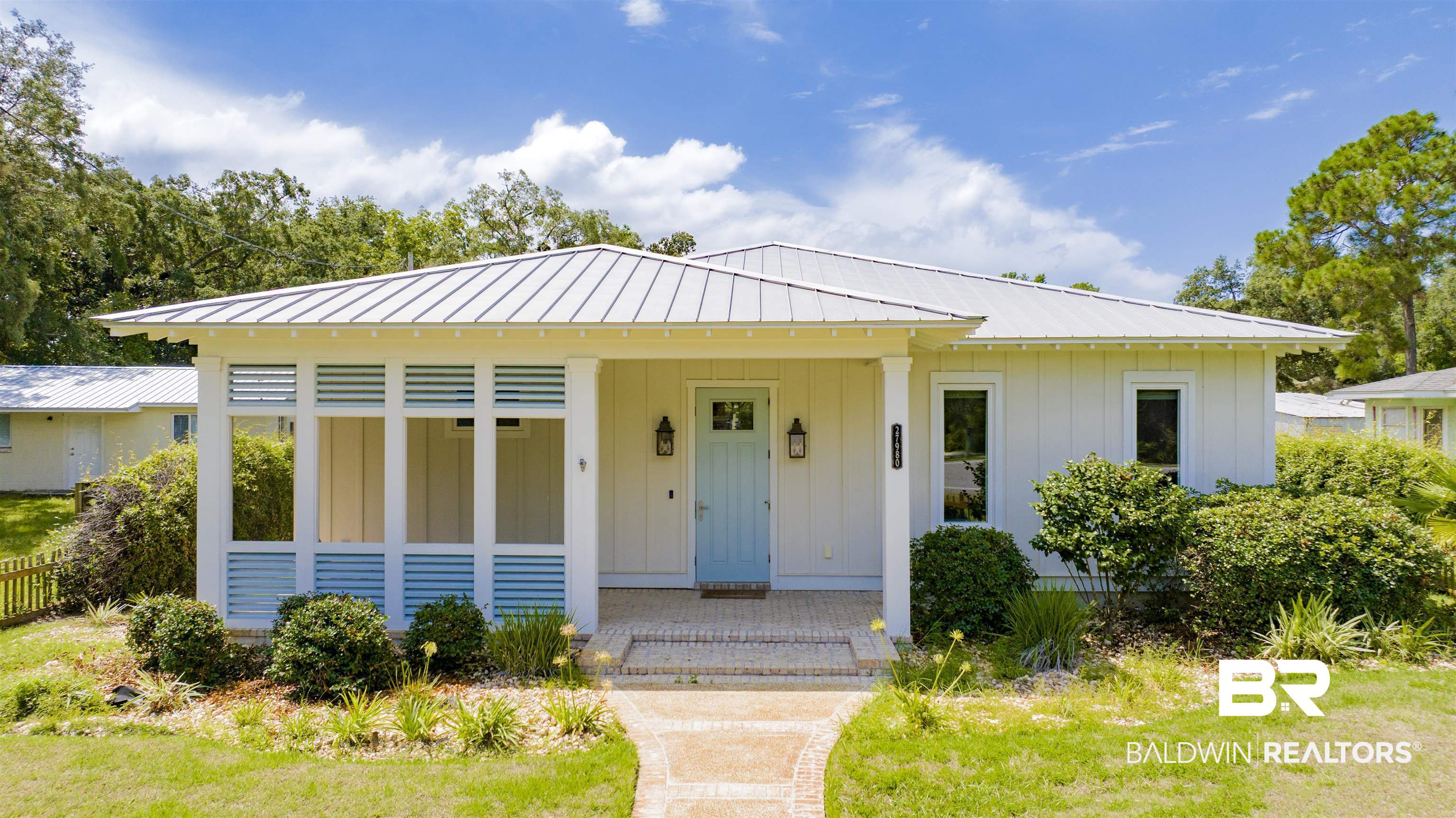 27980 Canal Road Orange Beach, AL 36561 - Photo 39 of 46 Bungalow-style house featuring board and batten siding, a porch, a metal roof, and a front lawn