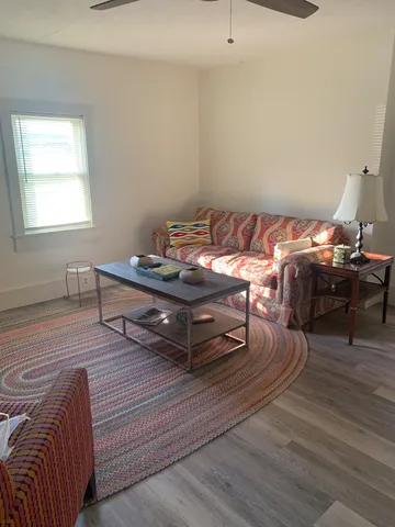 a kitchen with a table chairs a sink dishwasher window and cabinets