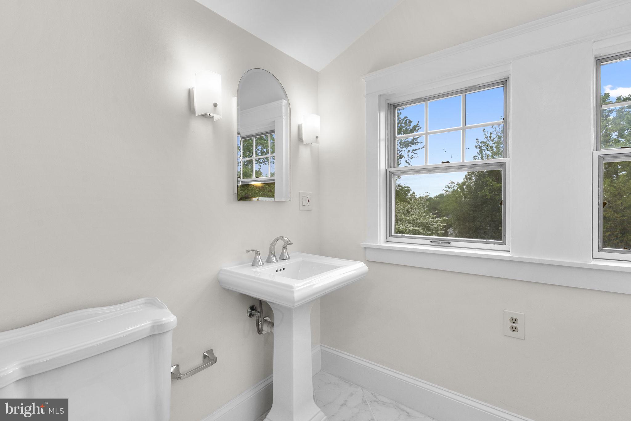 9120 Glenridge Road Silver Spring, MD 20910 - Photo 39 of 59 a bathroom with a sink a toilet and a mirror