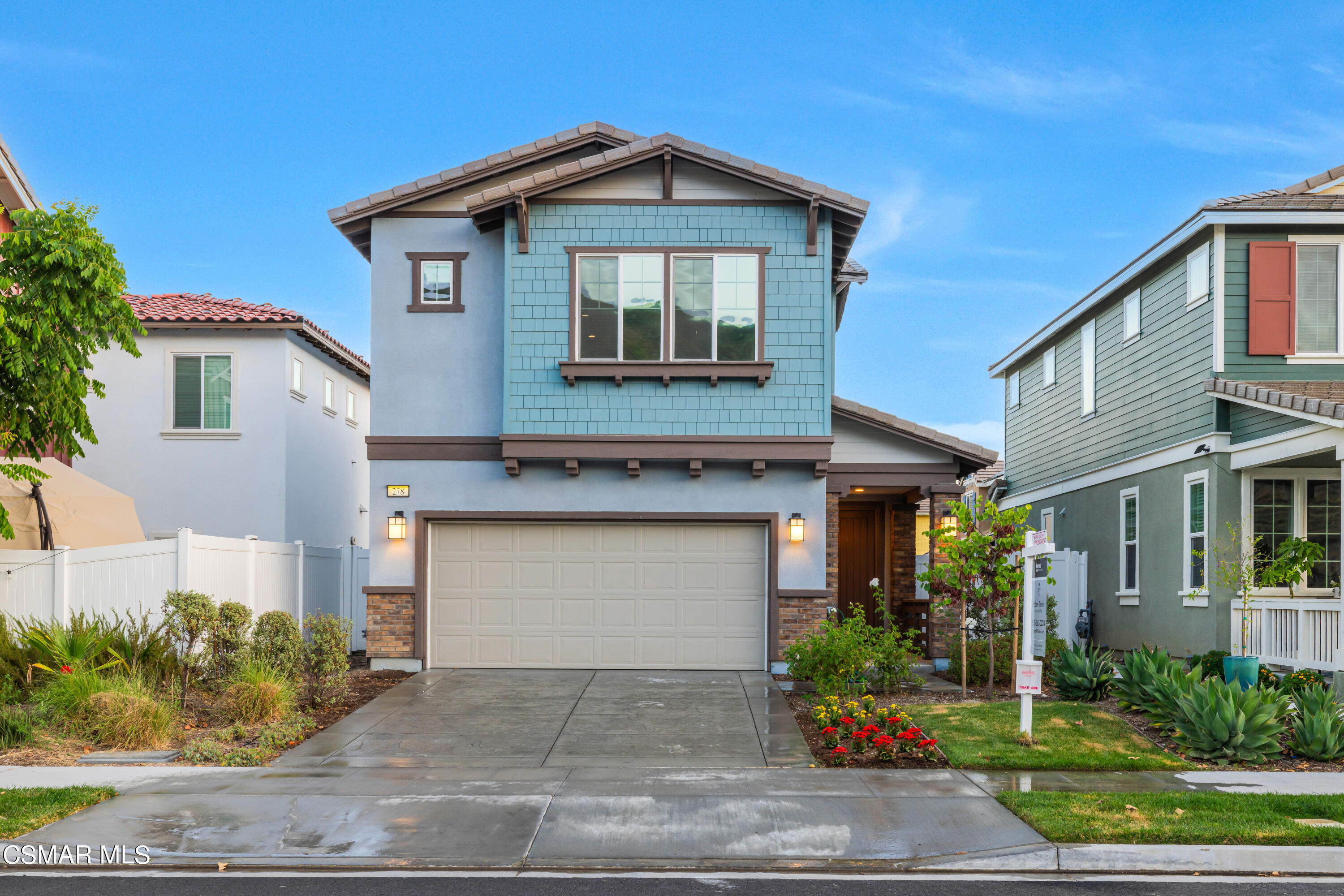 a front view of a house with garage