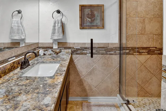 a bathroom with sink and mirror