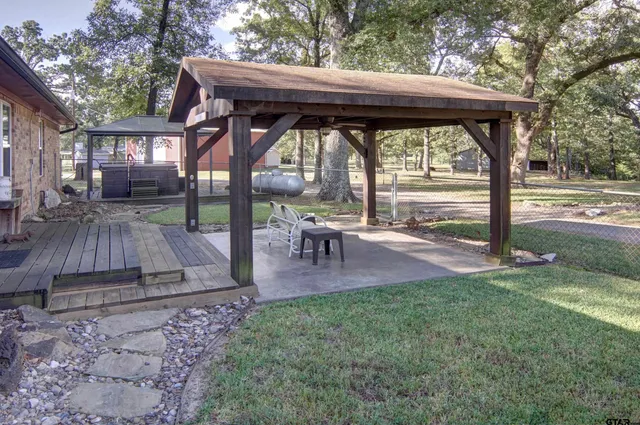 a view of a patio with table and chairs