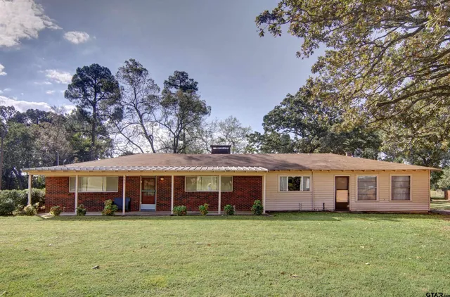 a house view with a sitting space and garden space