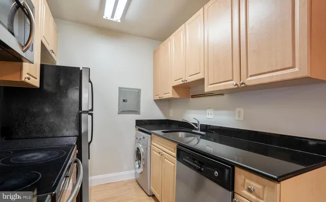 a kitchen with a refrigerator stove and cabinets