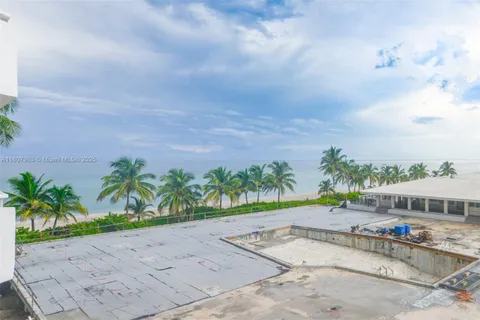 a view of a white house with a yard and plants