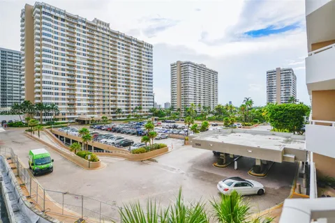 a view of a patio with couches table and chairs and potted plants