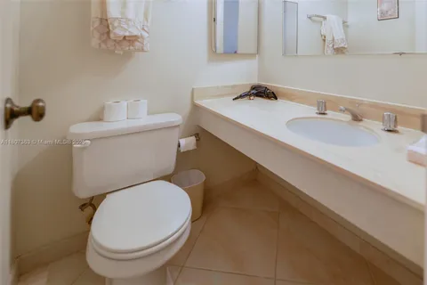 a white toilet sitting next to a bathroom sink