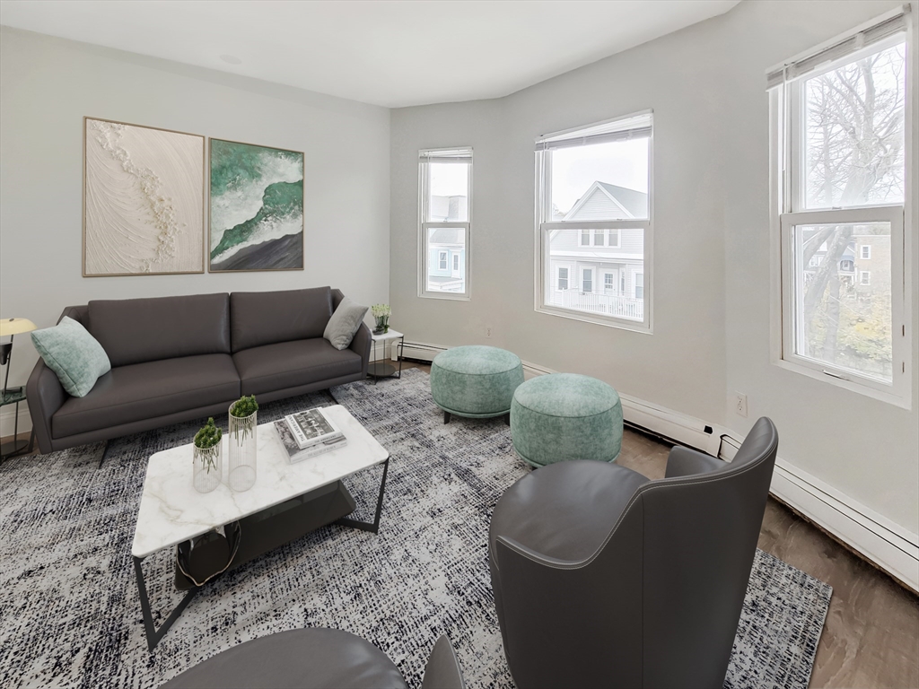 49 Rosedale Street, Unit 3 Boston, MA 02124 - Photo 3 of 10 a living room with furniture and a window