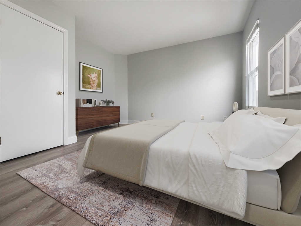 49 Rosedale Street, Unit 3 Boston, MA 02124 - Photo 5 of 10 a bedroom with a bed and a night stand