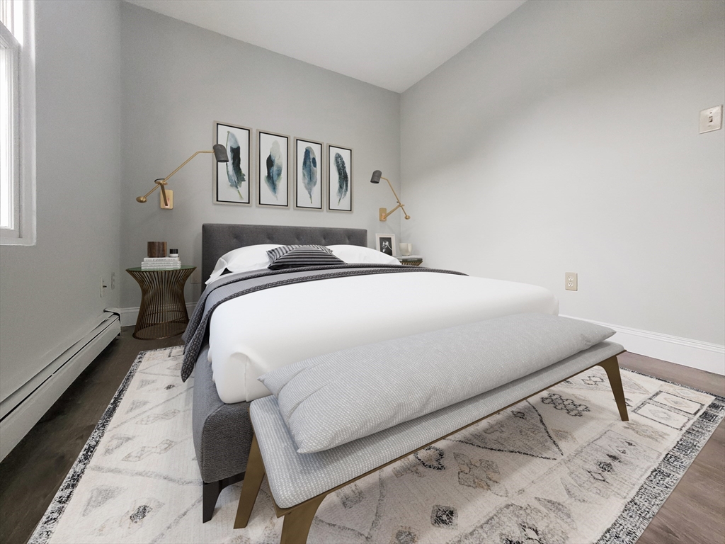 49 Rosedale Street, Unit 3 Boston, MA 02124 - Photo 7 of 10 a bedroom with a bed and a painting on the wall