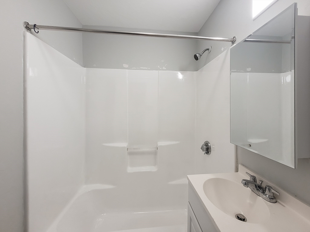 49 Rosedale Street, Unit 3 Boston, MA 02124 - Photo 9 of 10 a bathroom with a sink and a bathtub