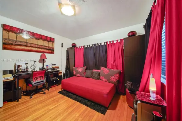 a bedroom with furniture and a large window