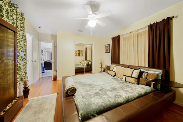 a bedroom with a large bed and a chandelier