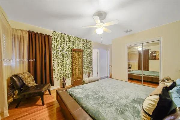 a spacious bedroom with a bed and a chandelier