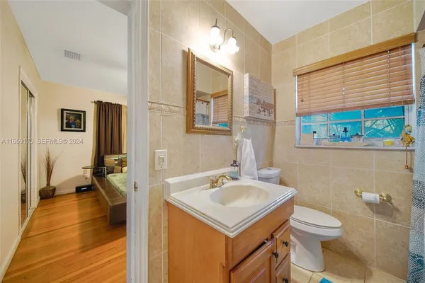 a bathroom with a sink toilet and a mirror