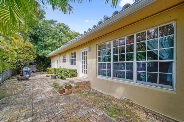 a view of house with backyard and seating space