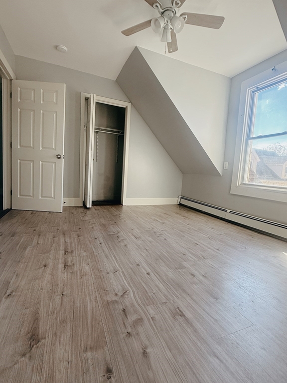 102 Warren Street, Unit 3 Lynn, MA 01905 - Photo 2 of 5 a view of an empty room with wooden floor and a window