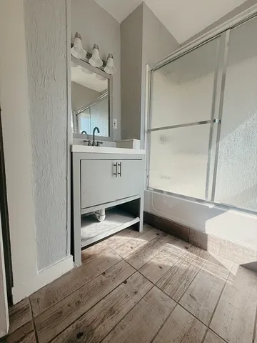 a bathroom with a sink mirror and vanity