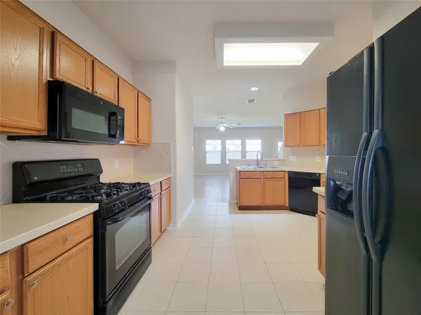 a kitchen with stainless steel appliances a refrigerator stove microwave and sink