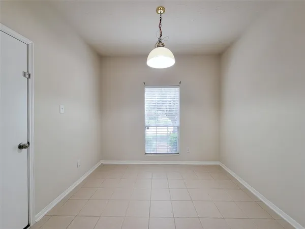 a view of a room with window and chandelier fan