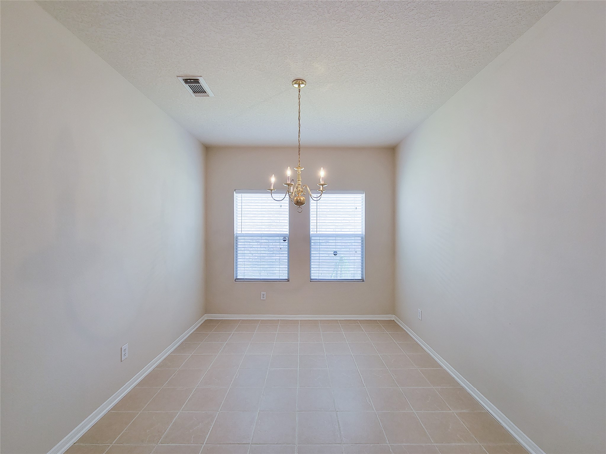 19330 Harvest Stream Way Houston, TX 77084 - Photo 21 of 50 an empty room with windows and chandelier