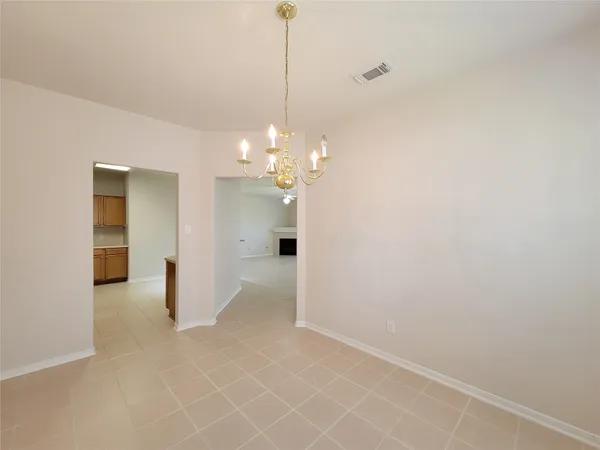 a view of a chandelier in big room and chandelier