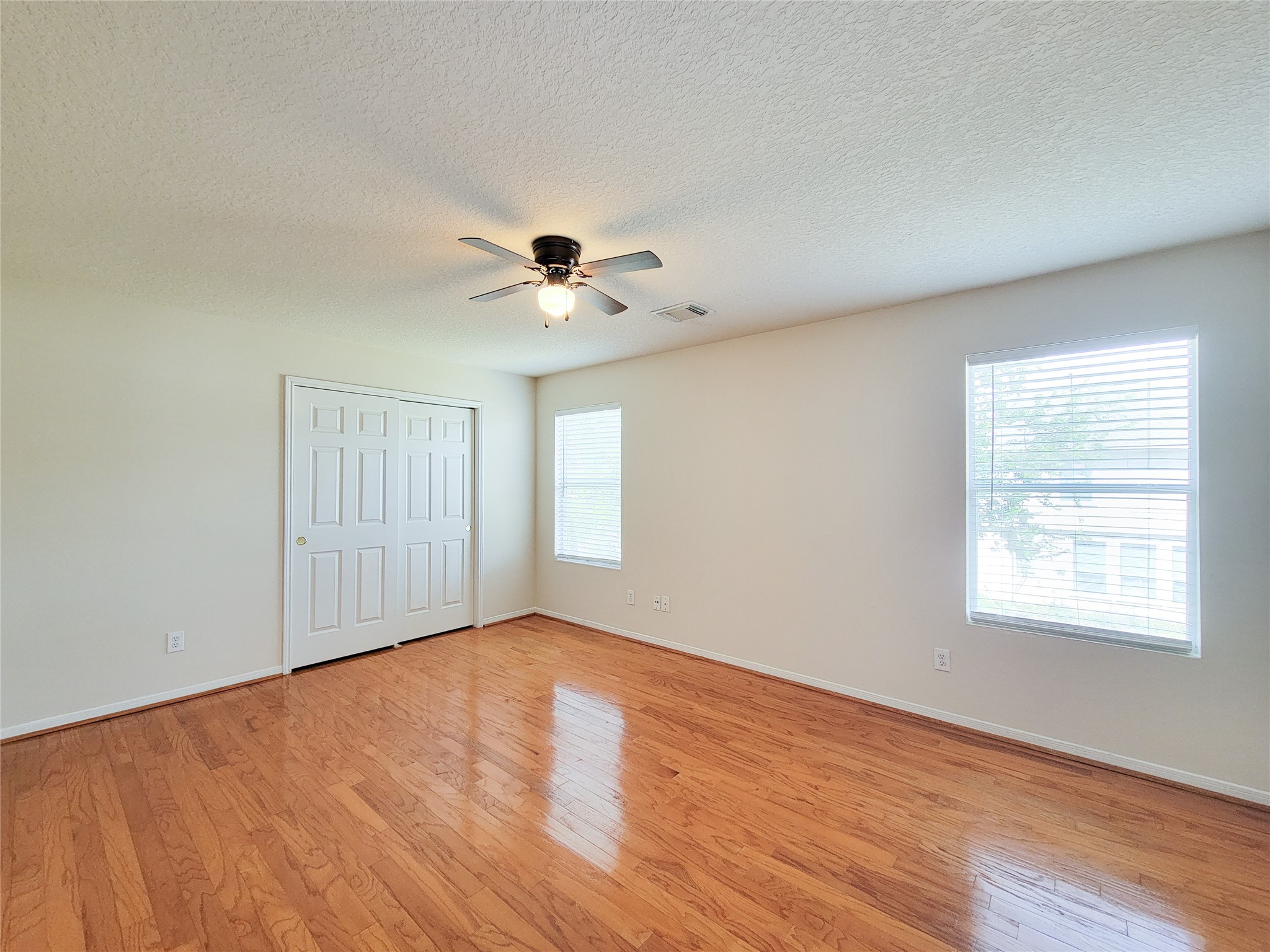 19330 Harvest Stream Way Houston, TX 77084 - Photo 28 of 50 a view of an empty room with a window and wooden floor