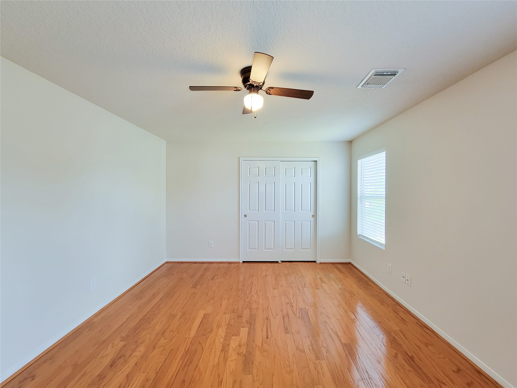 19330 Harvest Stream Way Houston, TX 77084 - Photo 29 of 50 a view of empty room with wooden floor and fan