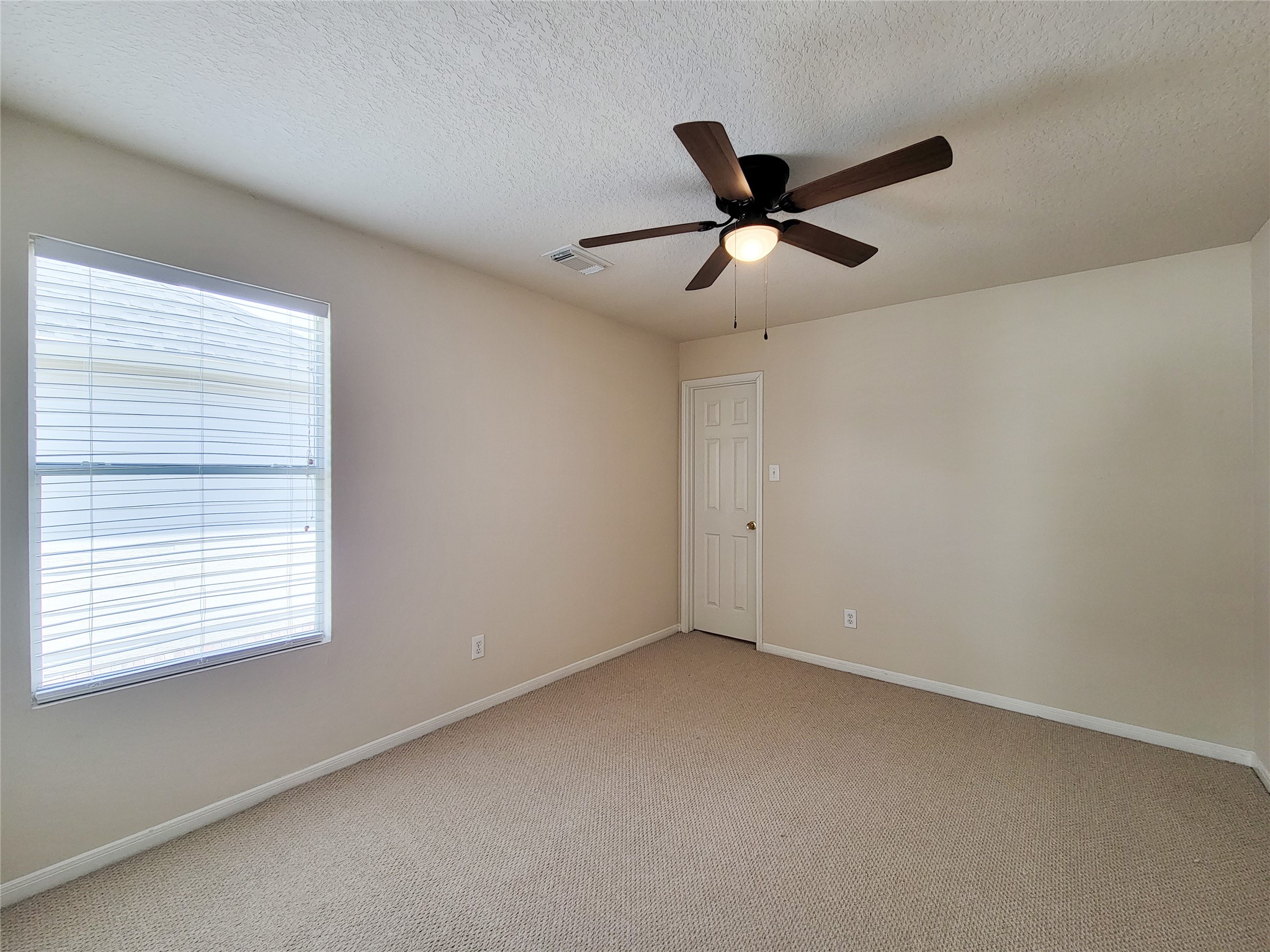 19330 Harvest Stream Way Houston, TX 77084 - Photo 36 of 50 a view of an empty room with a ceiling fan and window