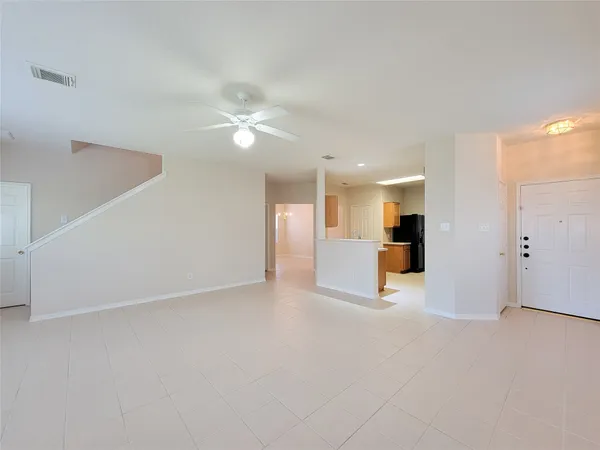 a view of an empty room with a kitchen