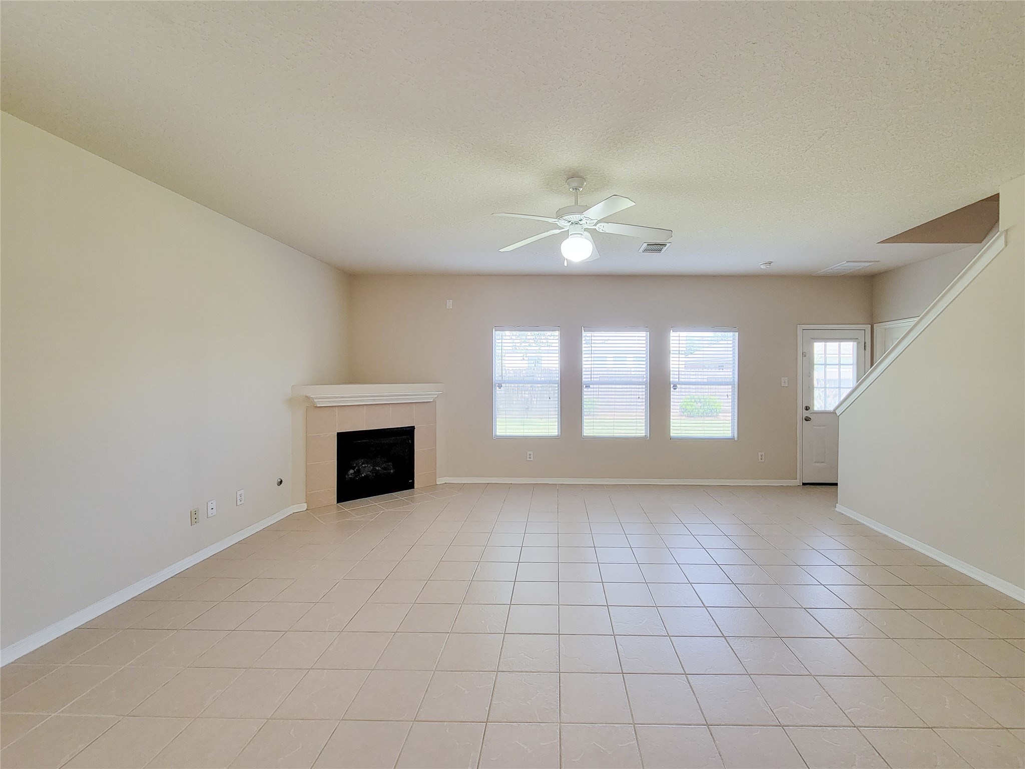 19330 Harvest Stream Way Houston, TX 77084 - Photo 9 of 50 an empty room with windows and fireplace