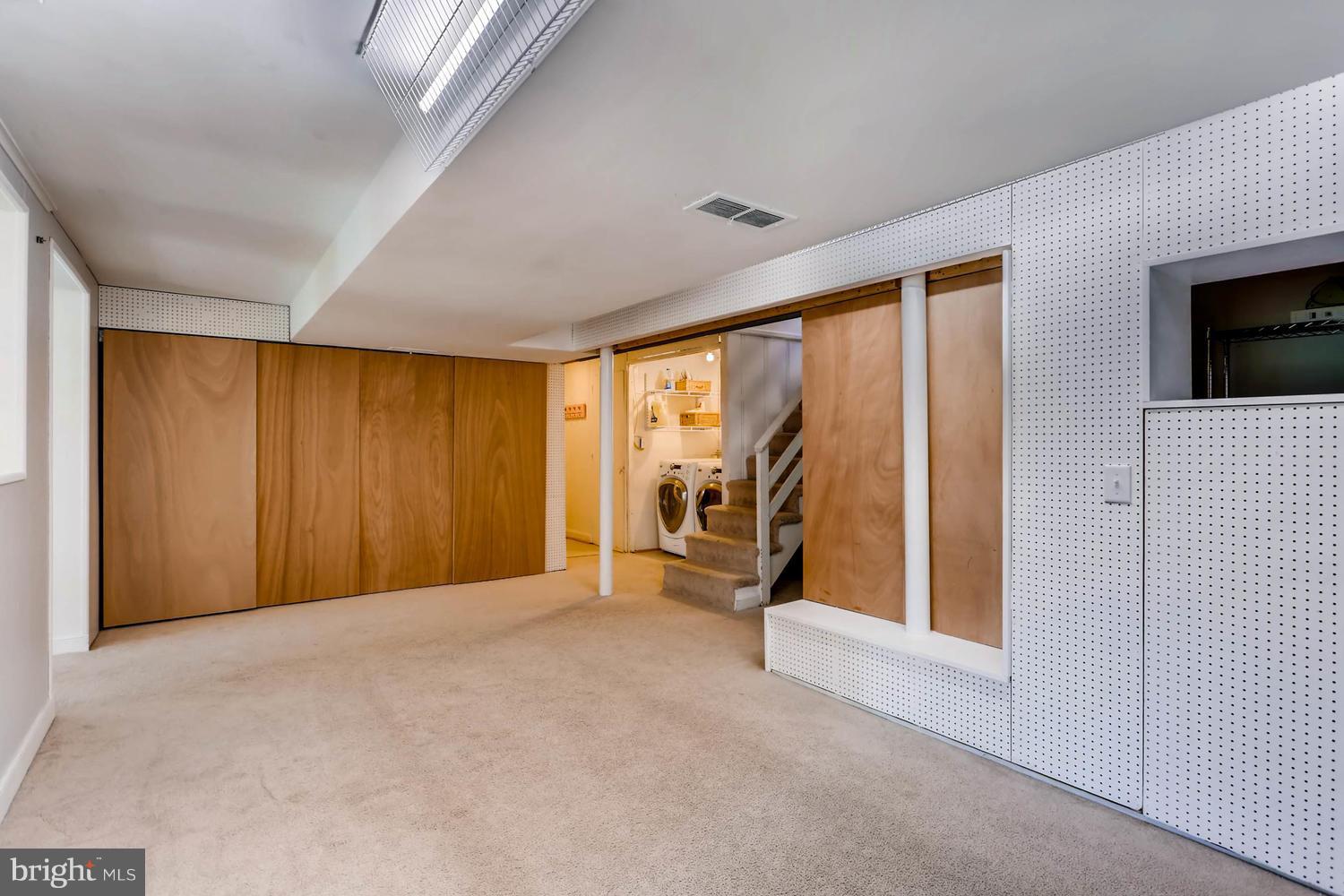 407 Terrace Way Baltimore, MD 21204 - Photo 22 of 28 Finished bsmnt play area, wood drs to storage rm