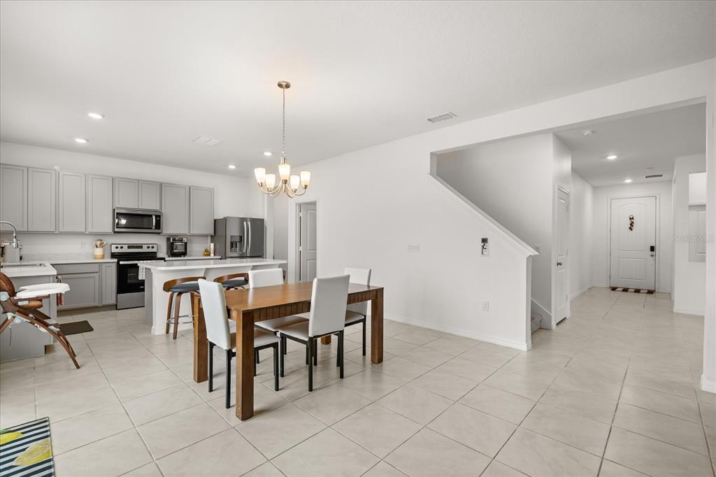 1470 Geranium Drive Mascotte, FL 34753 - Photo 11 of 23 a view of kitchen with dining area refrigerator and window