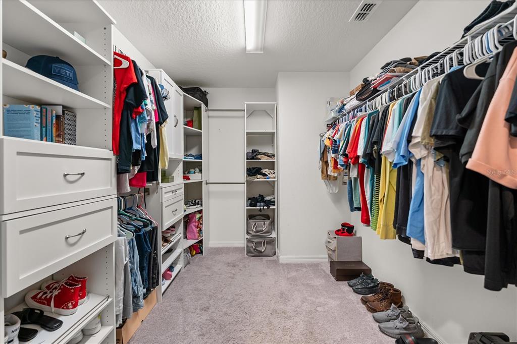 1470 Geranium Drive Mascotte, FL 34753 - Photo 16 of 23 a view of walk in closet with clothes and shoes